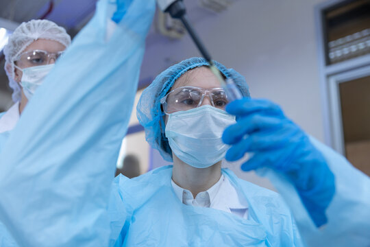 Women scientists using pipette and test tube during laboratory research for sample testing, biotechnology, scientific analysis, microbiology, medical research, laboratory.