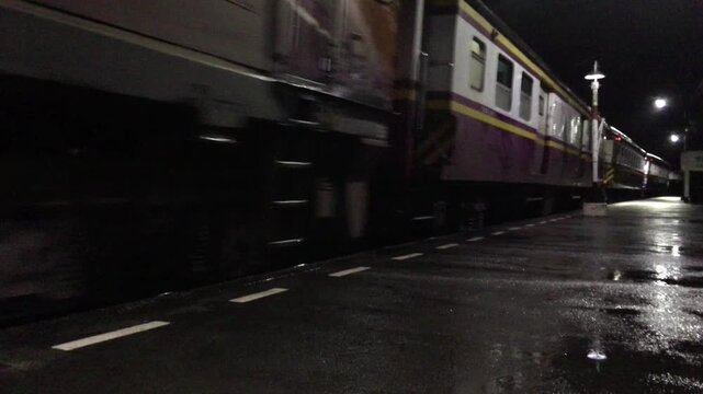 Night train traveling through city lights, modern transportation and urban mobility scene.