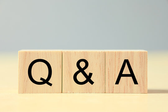 Wooden blocks displaying Q and A letters represent questions and answers, communication, customer support, information sharing, FAQ, problem solving, education, consultation, and online help.