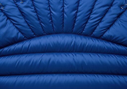 Blue down jacket texture showing puffy quilted fabric pattern.