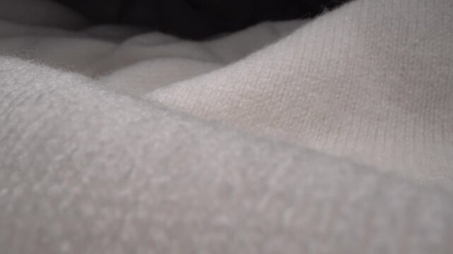 Close-up of soft white knitted wool sweater texture with a cozy warm feel