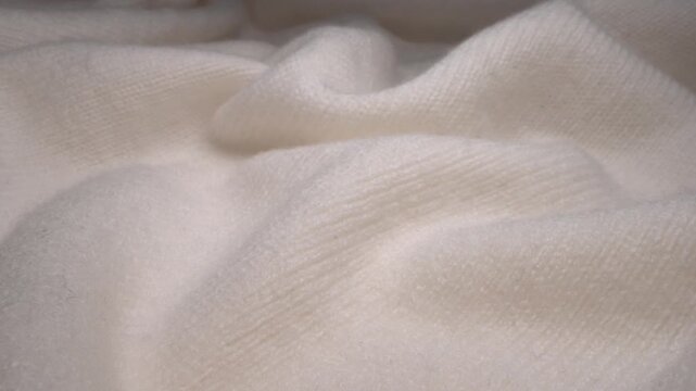 White natural wool knit texture creating a soft, warm and cozy textile background