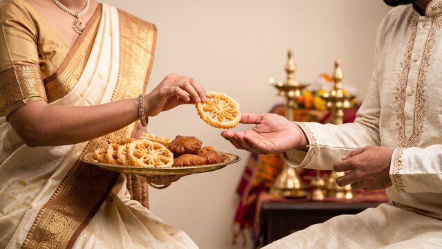 kokis, Sri Lankan New Year, sharing food, Aurudu, traditional sweets, couple, Sinhala New Year, hospitality, festive tradition, cultural celebration
