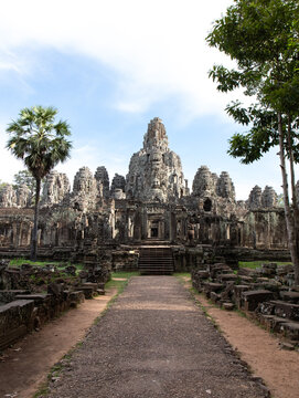 Bayon temple with stone face towers and path leading to entrance, Angkor Thom, Cambodia