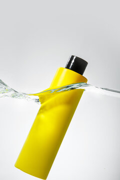 Floating Yellow Cosmetic Bottle in Water Splash