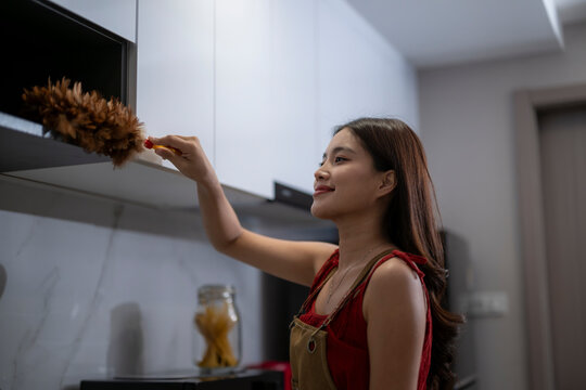 Woman Cleaning Kitchen Shelf with Duster, Housekeeping and Domestic Chore