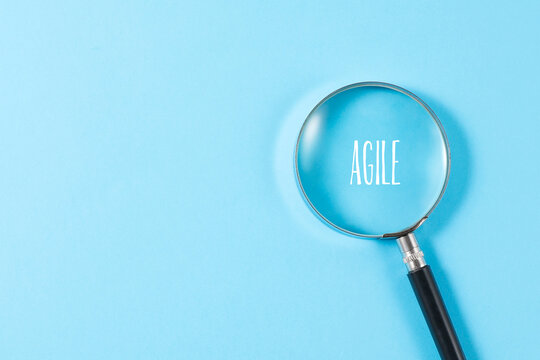 magnifying glass with agile text on blue background