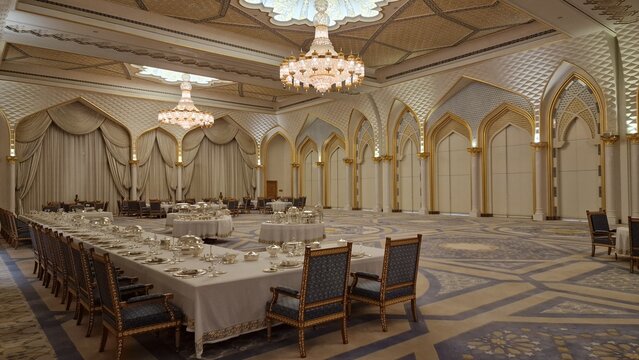 Ornate banquet hall interior with chandeliers and formal dining tables