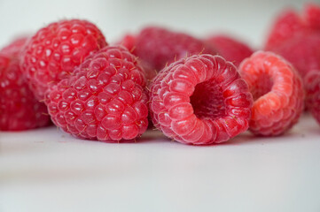 Ripe raspberries on a white background, close-up © Alina Yermakova