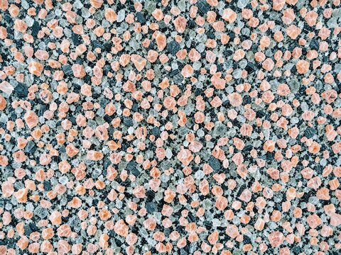 Rough Pink and Black Granite Bedrock Macro Texture Surface Background