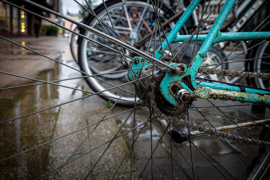 Rusty Turquoise Bicycle Chain and Rear Wheel After Rain