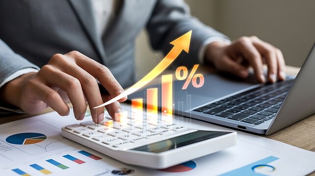 Business finance growth concept with financial analyst calculating data on calculator and laptop