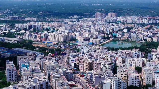 Residential Buildings with apartments, lake, greenery, road and ITC Manufacturer unit at ida bollaram, Mallampet, Bachupally, hyderabad, telangana, india. day time, push back shot, drone shot, 4k.