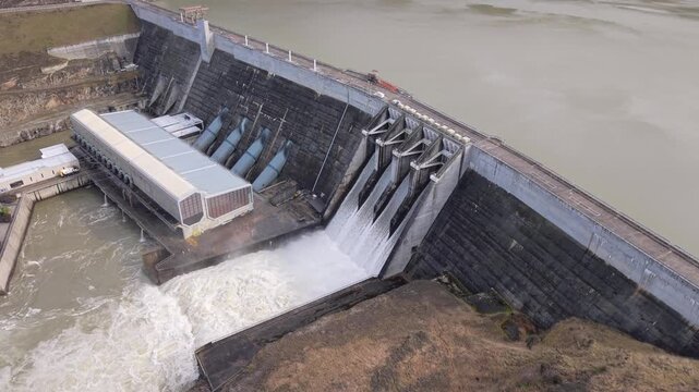 Water rushes through open spill gates at Clyde Dam, hydroelectric facility in rural NZ