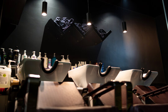 Modern hair salon interior with professional wash basins, providing hair care services