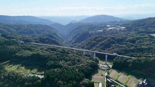 Aerial view of mountains and bridge in the countryside of Japan.