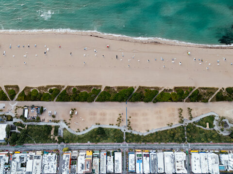 Aerial view of Miami Beach, Florida, showing a sandy shoreline, turquoise Atlantic Ocean and beachgoers