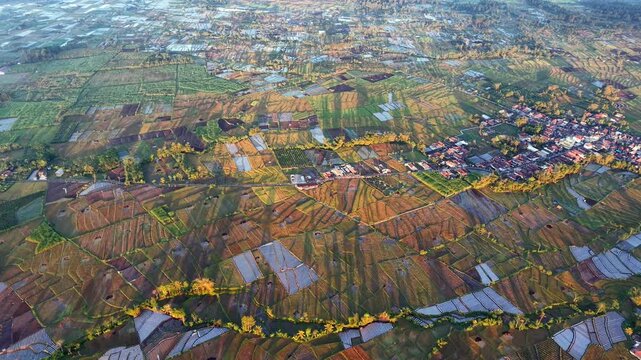 Golden light bathes patchwork fields and scattered villages at Pronojiwo, Lumajang