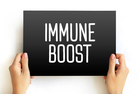 IMMUNE BOOST text held by hands. Health improvement concept focused on enhancing natural immunity and physical well-being through professional medical advice and proper care.