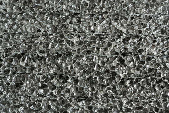 Black plastic foam macro texture, sponge material pattern