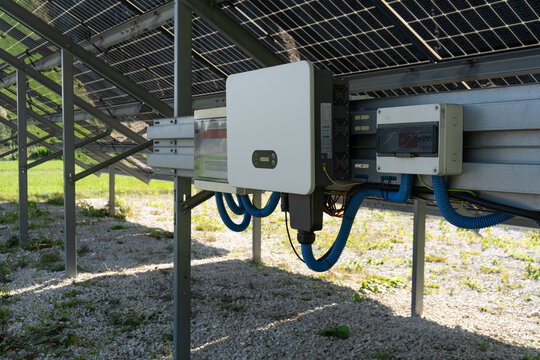 A solar inverter and junction boxes convert electricity on a local farm. Modern photovoltaic hardware manages green power distribution. A reliable system cuts enterprise electricity bills.