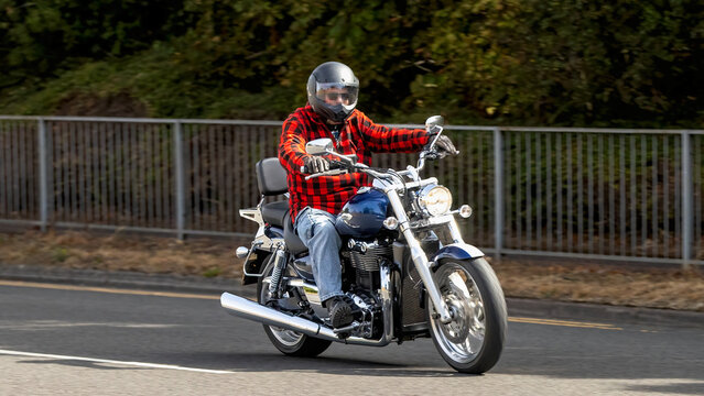 Milton Keynes,UK - Aug 2nd 2026:  Man riding a  2009 Triumph Thunderbird motorcycle driving on a British road