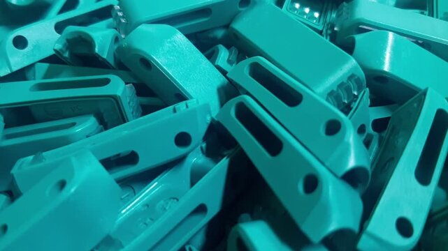 Smooth camera movement over industrial plastic parts texture. Abstract background of manufactured polymer components, mass production, injection molding elements and technical industry concept.