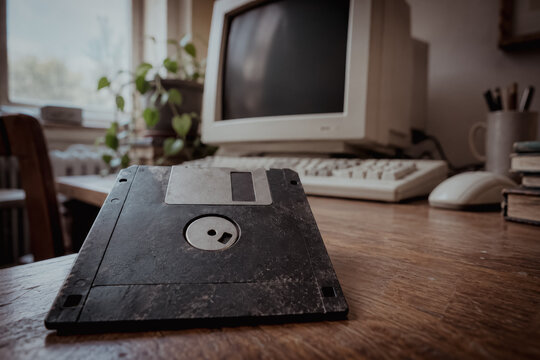 Old 3.5 inch floppy disk on a wooden desk
