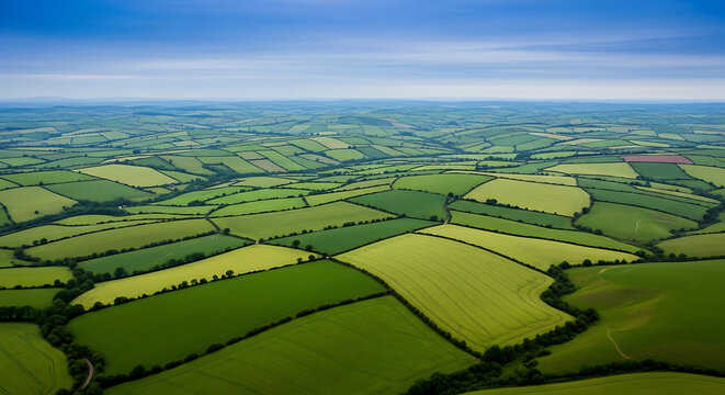 Green Hills and Valleys Patchwork Fields Under Blue Sky Aerial View Agricultural Patterns