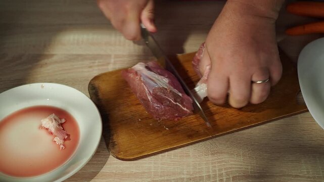 Man cut meat steak, beef pork neck cooking, Cook Butcher. The chef cuts the meat for cooking.