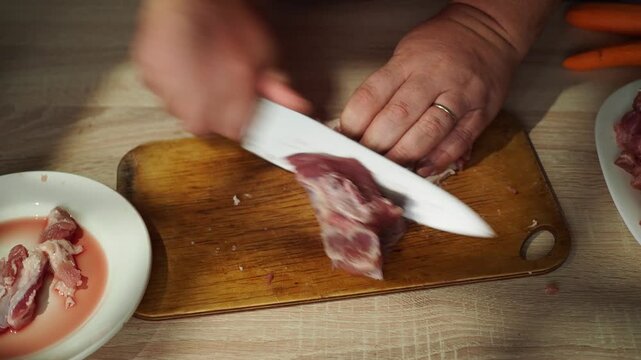 Man cut meat steak, beef pork neck cooking, Cook Butcher. The chef cuts the meat for cooking.