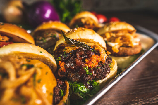 Mini burgers with assorted toppings and vegetables