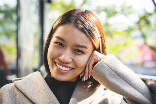 Young Vietnamese woman smiling in an outdoor portrait