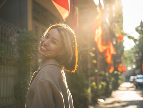 Young Vietnamese woman smiling outdoors