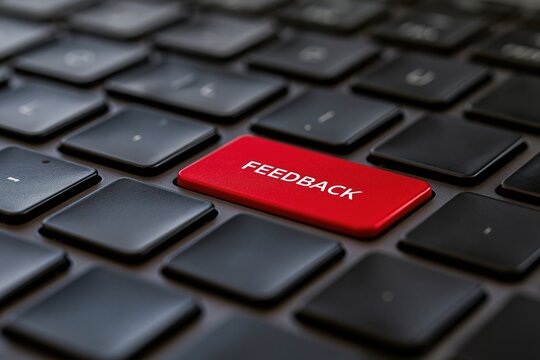 Close up red feedback key on black computer