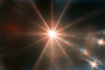 Obraz premium Bright starburst lens flare with sparkling particles in