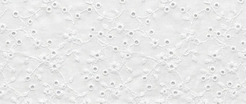 White cotton eyelet lace texture background. Embroidered floral broderie anglaise fabric pattern