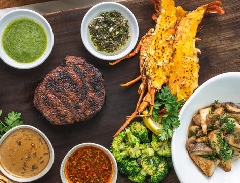 Grilled meat and seafood platter with vegetables and sauces