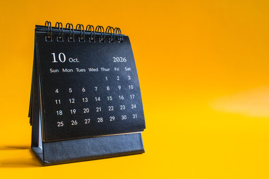 Desktop calendar showing October 2026 on yellow background, time management and planning concept