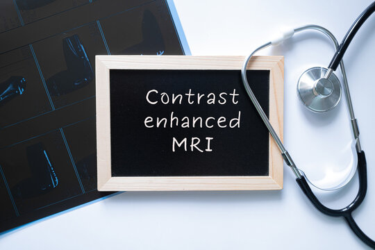 Contrast Enhanced MRI text on black chalkboard with stethoscope and tablet, medical imaging diagnostic concept