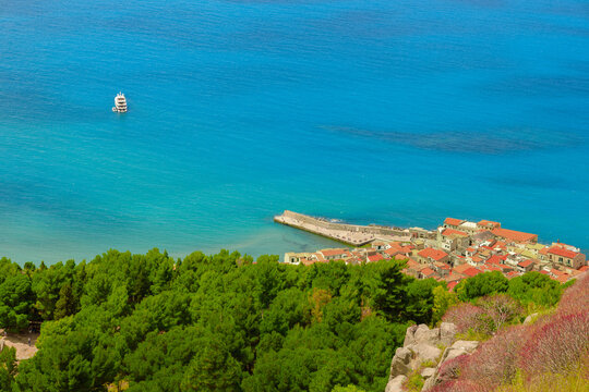 Aerial view coastal village pier in harbor district and luxury yacht on turquoise sea waters
