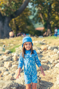 Carefree Little Girl Playing with Beach Toys on a Sunny Beach
