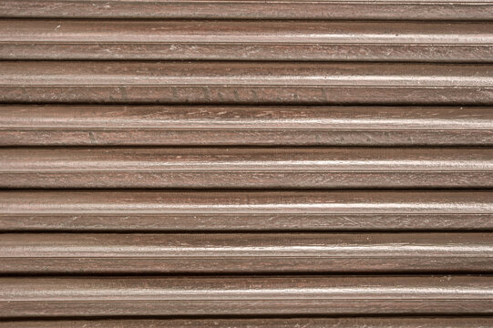 Brown wooden ribbed panel texture background with horizontal slatted grooves