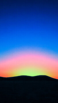 A beautiful sunset over a mountain range with vibrant colors and dramatic clouds vertical frame