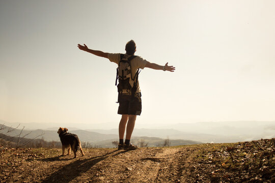 a boy and a dog in the mountains