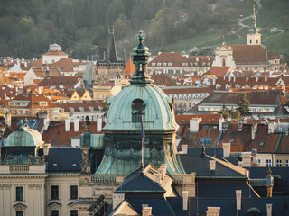 prague rooftops with historic domes and red tile roofs  © by Natallia