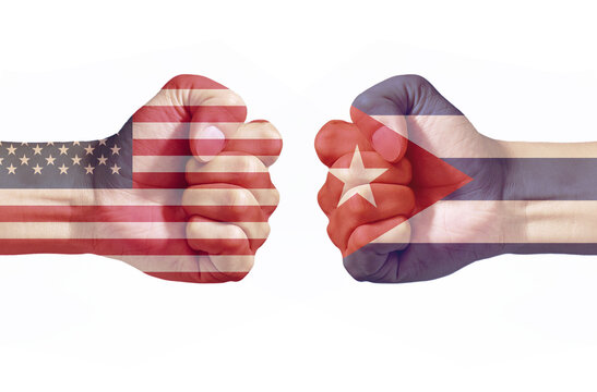 American and Cuba Flags on Opposing Fists Representing International Conflict