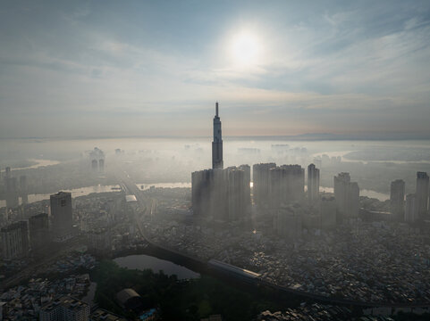 Landmark 81 rising above a hazy city beneath bright sun, Ho Chi Minh City, Vietnam