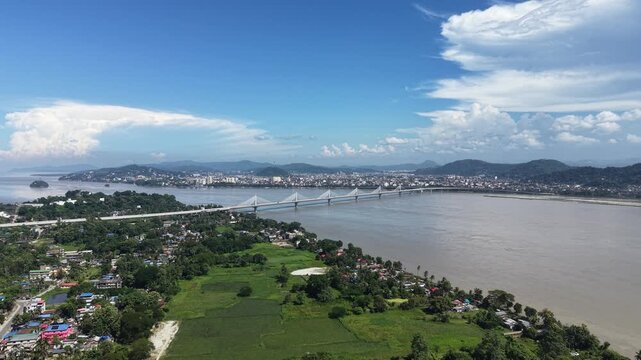 Aerial view of the clear blue sky, Guwahati city, and the bridge giving cinematic vibes