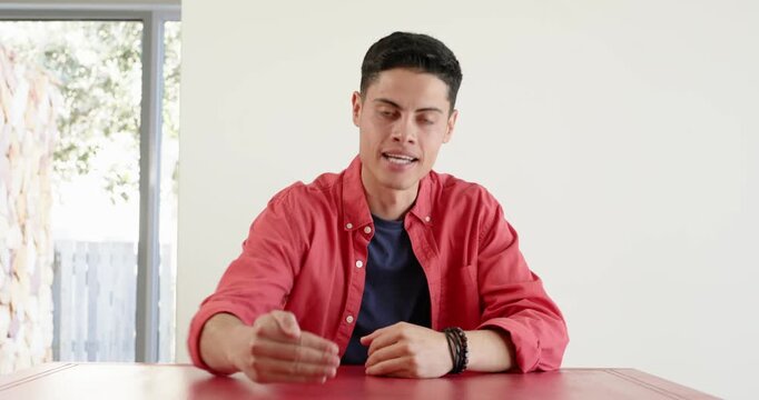 Close up of people talking to the camera, man sitting at table, talking and gesturing with hand